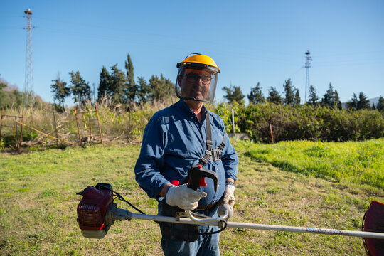 Man Holding Brush Cutter