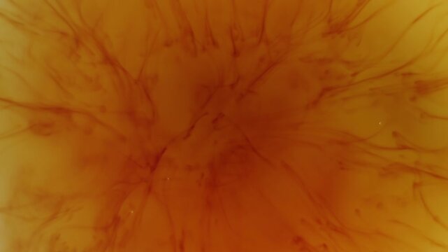 Flowing iodine particles dissolving in water, creating elegant abstract motion and smooth organic shapes.