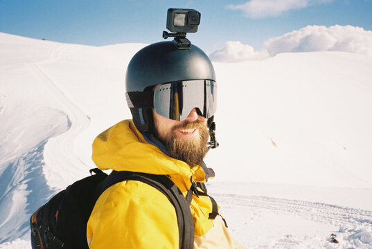 Portrait of a geared-up skier smiles at the camera