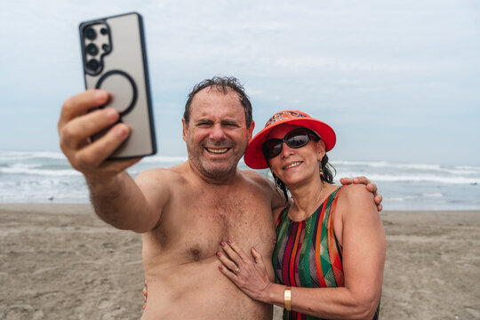 mature Couple Taking a Selfie Together on Beach 