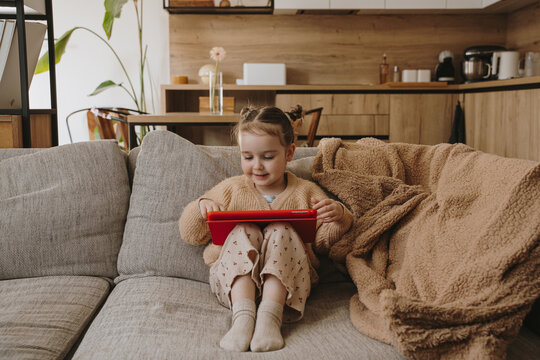 Baby girl playing on tablet.