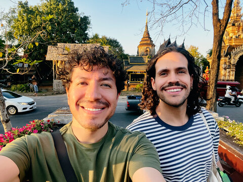 Two men taking selfie near temple in Chiang Mai Thailand