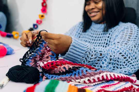 Crochet Artist Smiling While Working