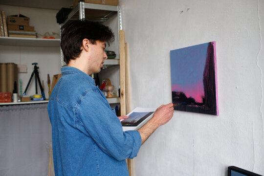 a man is painting a picture