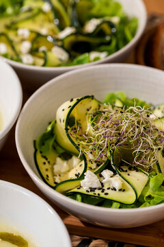 Fresh Salad With Cucumbers and Greens Served in Bowls