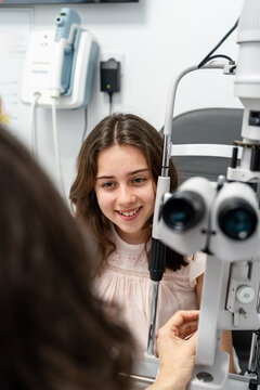 Optometrist Talking With Teen Patient During Eye Exam