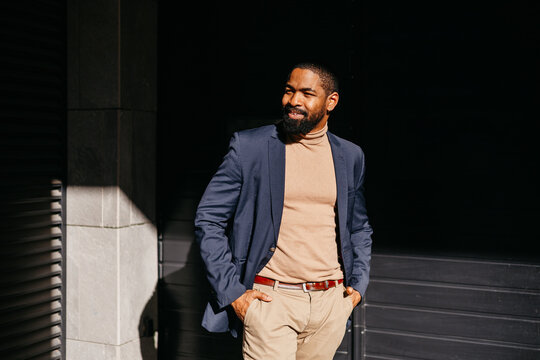 Stylish man stands outdoors