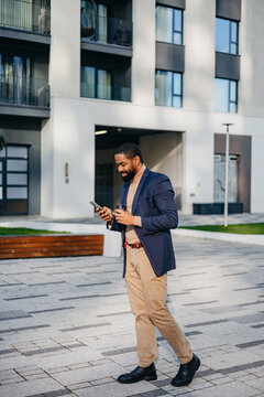 Businessman takes a coffee break in front of a building