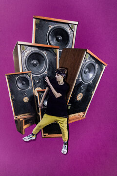Analog collage of a dancer in front of huge speakers
