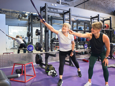 Woman Engaging in Strength Training with Personal Trainer
