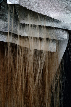 Close-up of long hair beneath layered translucent fabric