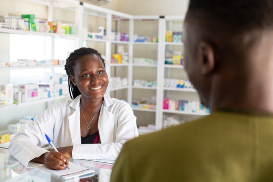 Smiling Pharmacist Assisting a Customer