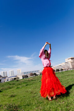 Woman moving in red tulle skirt 