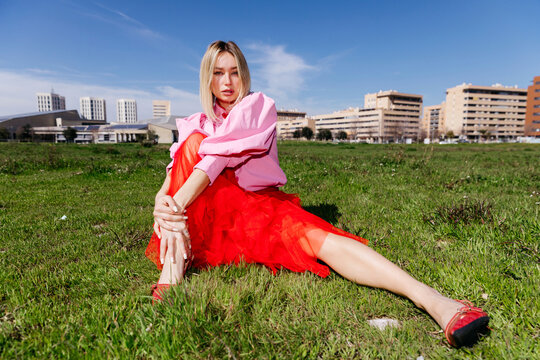 Woman  in trendy fashion outfit on grass