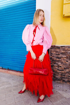 Woman in vibrant pink and red street fashion