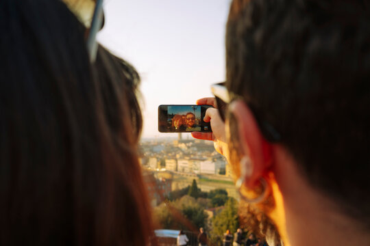 Tourist couple taking a selfie at Piazzale Michelangelo in Florence