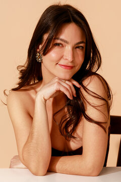 Woman Smiling With Hand Under Chin 