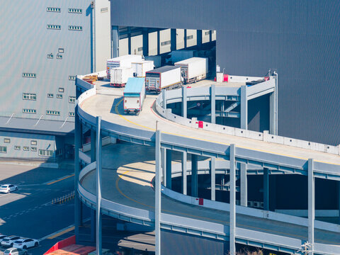 Delivery Trucks Queuing on Warehouse Spiral Ramp