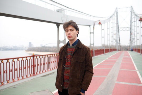 portrait of a man on a bridge