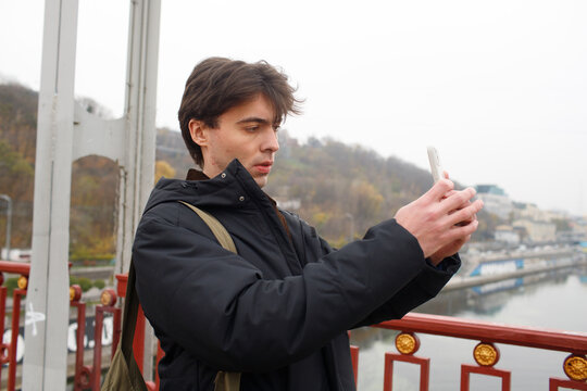 man filming on phone