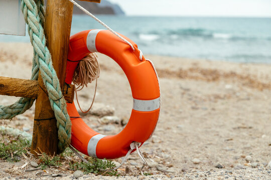 Orange lifebelt offering safety and rescue at beach