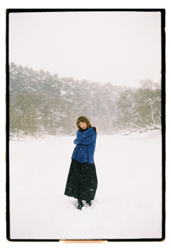 Film Portrait of a Woman in Blue Sweater During Snowfall