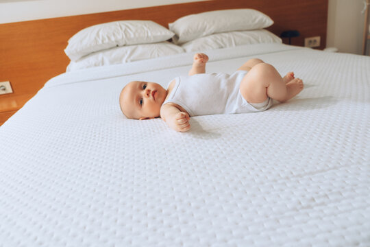 Baby lying on bed