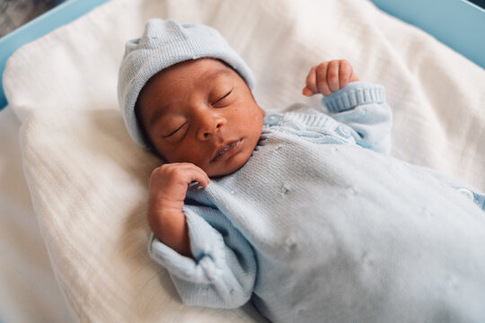 Sleeping newborn baby in hospital nursery crib