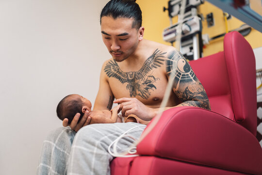 Father holding newborn baby during skin to skin contact