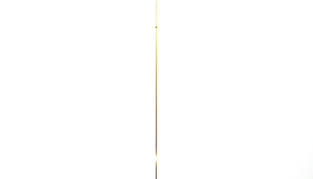 A slender vertical golden line is accented by a small golden bead slightly off-center on a pristine white background.