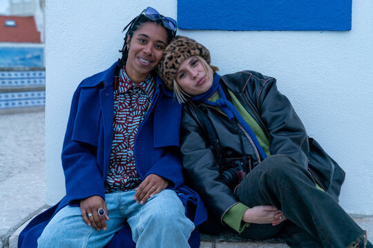 Two women sitting by a church bench 