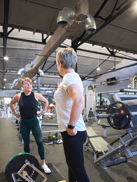 Weight training session with personal trainer at gym 