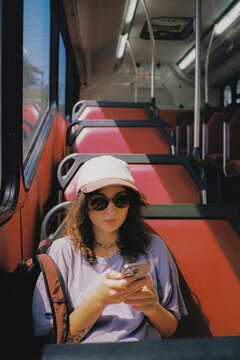 Woman using smartphone during the bus commute 