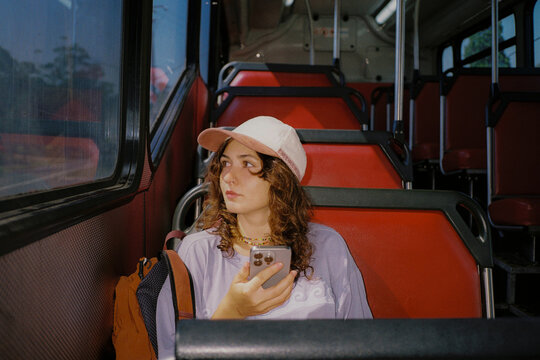 Woman using smartphone during the bus commute 