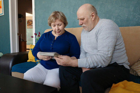 Senior couple sharing memories looking at album together