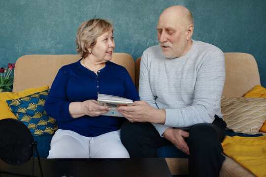 Happy senior couple bonding over memories at home