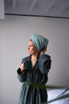 Woman in Bathrobe With Towel Holding Coffee Mug