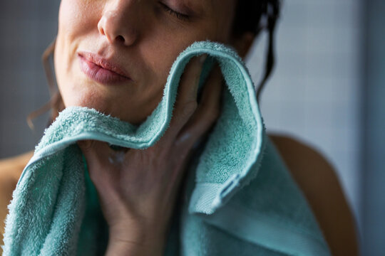 Woman Drying Face With Soft Towel After Shower