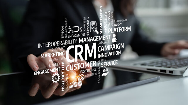 Business professional using a digital touchscreen featuring CRM and marketing concepts to enhance customer engagement and drive innovation in a modern workspace. Tessel