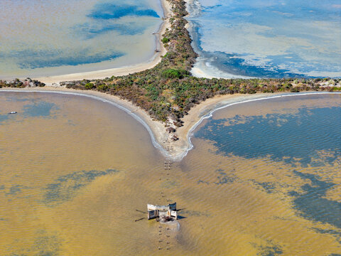 Cross shaped levee banks and irrigation gate at a coastal salt farm