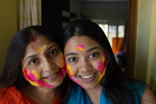Colourful face smudged with colourful powders in holi festival