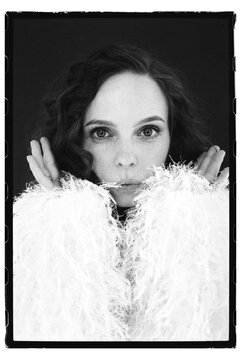 Woman posing with hands on cheeks in soft fur