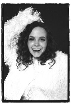 Woman smiling and posing in fluffy white outfit