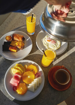 Breakfast Spread on a Table With Fruit, Drinks, and Eggs