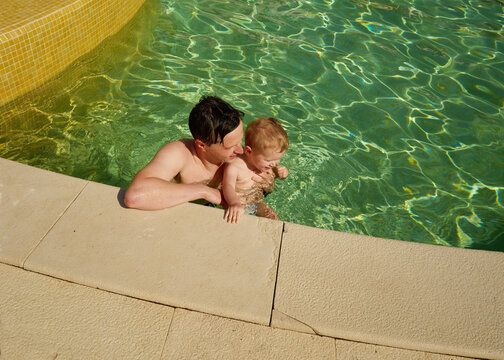 Father and Child Enjoy Time Together in Pool