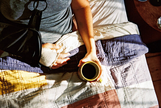 Overhead view of woman in bed with broken arm