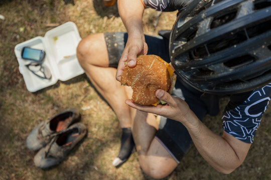 Cyclist eating a burger