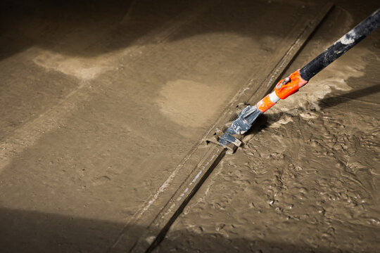 Screeding Fresh Concrete Floor