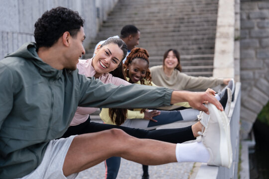 Group of friends stretching outdoors on a sunny day