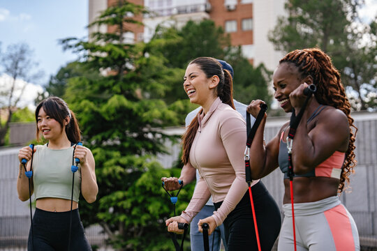 Group exercise with resistance bands in a park setting